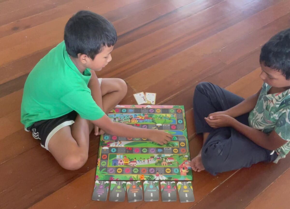 Julian and Landon playing Ready Fi Di Road on the floor at home