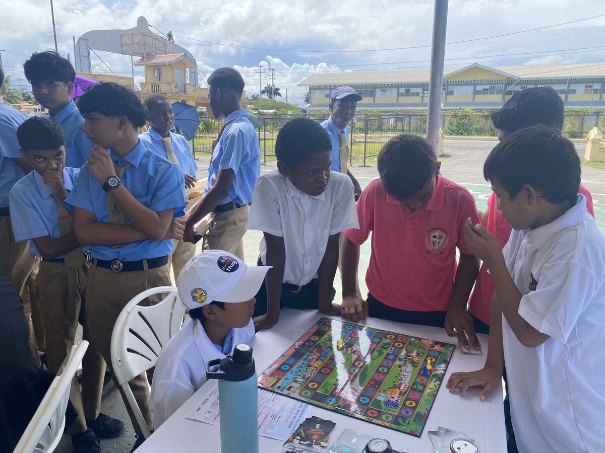 Students in uniform gathered around the board